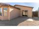 Home featuring a low-maintenance gravel backyard with a covered patio and desert landscaping at 6042 W Warner St, Phoenix, AZ 85043