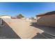 Large backyard with gravel ground cover enclosed by a concrete block wall, providing a low-maintenance outdoor space at 6042 W Warner St, Phoenix, AZ 85043