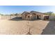 Spacious gravel backyard featuring privacy wall, desert landscaping, and covered patio, perfect for outdoor living at 6042 W Warner St, Phoenix, AZ 85043