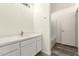 Bright bathroom featuring a modern vanity with white countertops and wood-look tile floors at 6042 W Warner St, Phoenix, AZ 85043