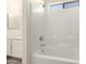 Freshly renovated bathroom featuring a shower over tub with white tiled walls at 6042 W Warner St, Phoenix, AZ 85043