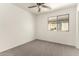 Comfortable bedroom featuring carpeted floors, a window, and light-colored walls at 6042 W Warner St, Phoenix, AZ 85043