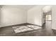 Bright living room with modern dark tile flooring, a neutral palette, and access to kitchen at 6042 W Warner St, Phoenix, AZ 85043