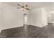 Spacious living room features dark tile floors and a modern ceiling fan at 6042 W Warner St, Phoenix, AZ 85043