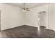 Bright living room with modern dark tile flooring, a neutral palette, and ceiling fan at 6042 W Warner St, Phoenix, AZ 85043