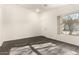 Bright living room with modern dark tile flooring, a neutral palette, and natural light at 6042 W Warner St, Phoenix, AZ 85043