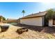 View of the backyard featuring drought-tolerant landscaping and pool beyond at 614 W Mcnair St, Chandler, AZ 85225