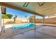 Backyard view of a pool with a diving board surrounded by a patio and block fence at 614 W Mcnair St, Chandler, AZ 85225