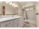 Bright bathroom featuring a white vanity with modern hardware and a shower-tub combination at 614 W Mcnair St, Chandler, AZ 85225