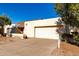 Beige single-story home with a large, attached two-car garage and a spacious driveway at 614 W Mcnair St, Chandler, AZ 85225