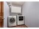 Laundry room featuring a washer, dryer, and white and blue striped walls at 614 W Mcnair St, Chandler, AZ 85225