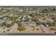 Aerial view of a home featuring a circular driveway, lush desert landscaping, and a backyard pool at 6420 E Gary Rd, Scottsdale, AZ 85254