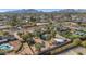 Panoramic aerial view showcasing residences with swimming pools, mature trees and desert landscaping, with mountains in the background at 6420 E Gary Rd, Scottsdale, AZ 85254