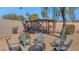 Secluded backyard with covered bird aviary and fire pit with seating at 6420 E Gary Rd, Scottsdale, AZ 85254