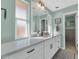 This mint-green bathroom features a white quartz countertop and double windows at 6420 E Gary Rd, Scottsdale, AZ 85254