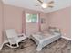 This pink bedroom features a ceiling fan and chair at 6420 E Gary Rd, Scottsdale, AZ 85254