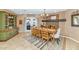 Inviting dining room featuring a fireplace, wood table, and doors to an outdoor patio at 6420 E Gary Rd, Scottsdale, AZ 85254