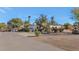 Side exterior view of a charming house with a basketball hoop and desert landscaping at 6420 E Gary Rd, Scottsdale, AZ 85254