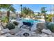 Tranquil pool area with lounge chairs, lush foliage, and mature palm trees at 6420 E Gary Rd, Scottsdale, AZ 85254