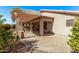 Spacious backyard showcasing a covered patio area with ample seating, ideal for outdoor living at 674 S 231St Dr, Buckeye, AZ 85326