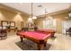 A warm billiard room featuring two pool tables with red felt and ambient lighting at 674 S 231St Dr, Buckeye, AZ 85326