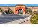 Attractive clubhouse entrance with a terracotta-colored archway and well-kept grounds at 674 S 231St Dr, Buckeye, AZ 85326