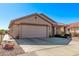 Charming single-story home with a two-car garage and desert landscaping at 674 S 231St Dr, Buckeye, AZ 85326