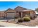 Well-maintained home featuring desert landscaping, a two-car garage, and neutral color scheme at 674 S 231St Dr, Buckeye, AZ 85326