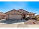 Charming single-story home showcasing a well-maintained front yard and attached two-car garage at 674 S 231St Dr, Buckeye, AZ 85326