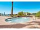 Inviting community hot tub with lounge chairs, lush greenery, and a sunny, clear blue sky at 674 S 231St Dr, Buckeye, AZ 85326