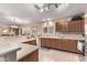 Well-lit kitchen boasting ample counter space, wooden cabinetry, and tile backsplash at 674 S 231St Dr, Buckeye, AZ 85326