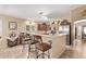 Kitchen featuring an island with barstool seating, stainless steel appliances, and tile flooring at 674 S 231St Dr, Buckeye, AZ 85326