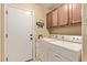 Functional laundry room with a side-by-side washer and dryer, plus cabinet storage space at 674 S 231St Dr, Buckeye, AZ 85326