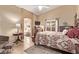 Serene main bedroom with a decorative rug, ceiling fan, and access to the ensuite bathroom at 674 S 231St Dr, Buckeye, AZ 85326