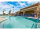 Resort-style community swimming pool with comfortable lounge chairs and scenic landscaping at 674 S 231St Dr, Buckeye, AZ 85326