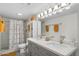 Clean bathroom featuring a double sink vanity, shower, and neutral color scheme at 6834 E 4Th St # 6, Scottsdale, AZ 85251