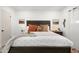 Cozy main bedroom with dark wood furnishings, soft, neutral color palette and crisp, white walls at 6834 E 4Th St # 6, Scottsdale, AZ 85251