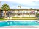 Apartment building next to a pool with lounge chairs on the lawn and blue tiled pool at 6834 E 4Th St # 6, Scottsdale, AZ 85251