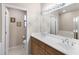 Bright bathroom with dual sinks, tile floors, and a large mirror with decorative lighting at 705 W Queen Creek Rd # 2006, Chandler, AZ 85248