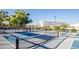 Outdoor pickleball court with net, court lines, and scenic view of a building and lake in background at 705 W Queen Creek Rd # 2006, Chandler, AZ 85248