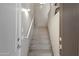 Carpeted staircase featuring a handrail and modern lighting fixtures near entry at 705 W Queen Creek Rd # 2006, Chandler, AZ 85248