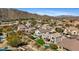 Aerial view of houses in a neighborhood showing mountain views and a golf course at 7357 E Rochelle Cir, Mesa, AZ 85207