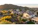 A high-angle view of a residential community with homes featuring pools and beautiful desert landscaping at 7357 E Rochelle Cir, Mesa, AZ 85207