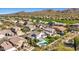 Aerial view of the property showcasing the backyard pool, nearby golf course, and mountain views at 7357 E Rochelle Cir, Mesa, AZ 85207