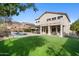 Expansive backyard features lush lawn, inviting pool, comfortable seating, and relaxing patio for outdoor entertaining at 7357 E Rochelle Cir, Mesa, AZ 85207