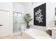 Well-lit bathroom with a soaking tub, a separate glass shower, and contemporary design elements at 7357 E Rochelle Cir, Mesa, AZ 85207