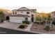 Exterior front elevation view of a large home featuring a three-car garage, well-manicured landscaping, and a tile roof at 7357 E Rochelle Cir, Mesa, AZ 85207