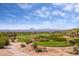 Scenic view of a lush golf course with blue skies and distant mountain views, creating a picturesque landscape at 7357 E Rochelle Cir, Mesa, AZ 85207