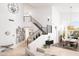 Spacious living room features high ceilings, travertine floors, and a grand staircase with wrought iron railings at 7357 E Rochelle Cir, Mesa, AZ 85207