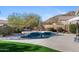 The backyard features a stunning pool and patio with beautiful landscaping and views at 7357 E Rochelle Cir, Mesa, AZ 85207